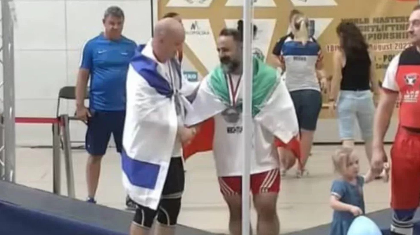 Iranian weightlifter banned for photo with Israeli