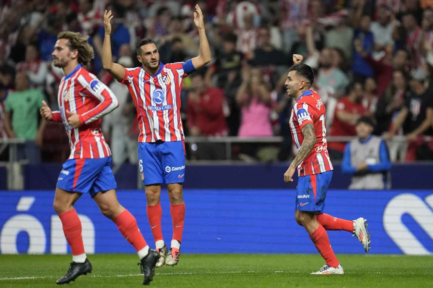 Atletico equalizes late against Madrid in derby interrupted after objects thrown on the field