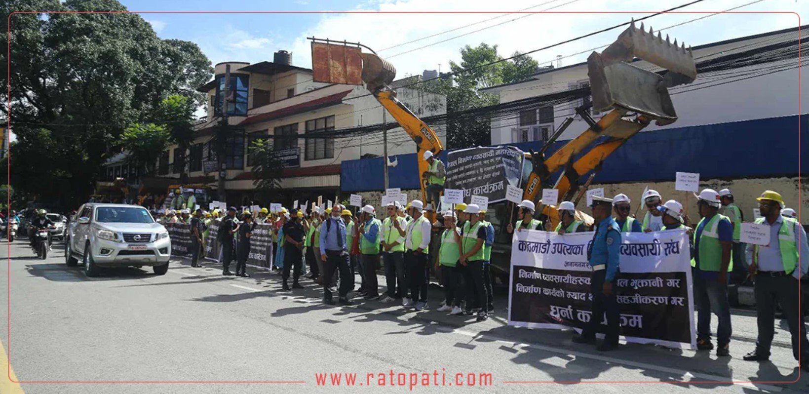 Construction workers demonstrate a protest in Baluwatar with dozers