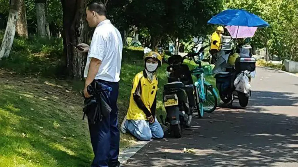 Fury in China as deliveryman kneels before guard