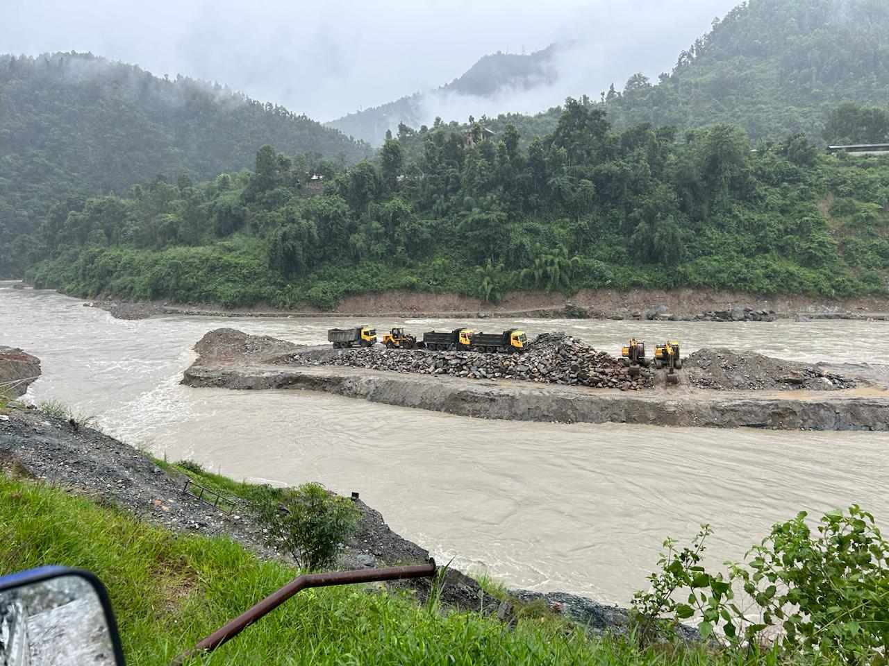 Tipper and excavators stuck in Trishuli river